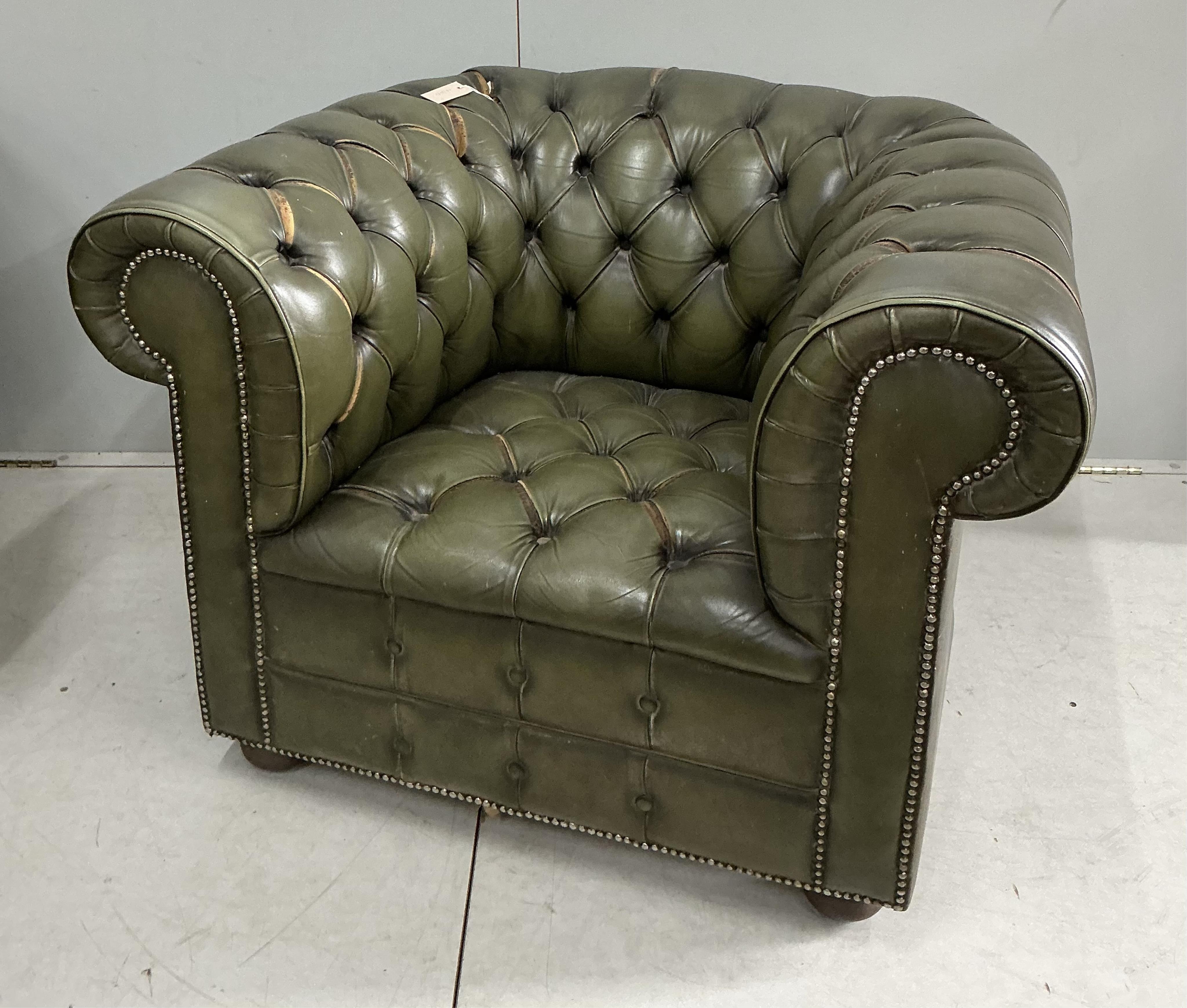 A pair of Chesterfield style buttoned green leather club armchairs, width 104cm, depth 92cm, height 74cm